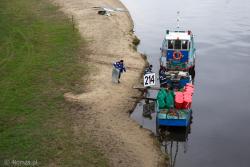 Barka Wód Polskich przy plaży miejskiej. Pracownicy ładują znaczniki i boje, które ustawiane są na Narwi, aby jednostki mogły pływać rzeką.